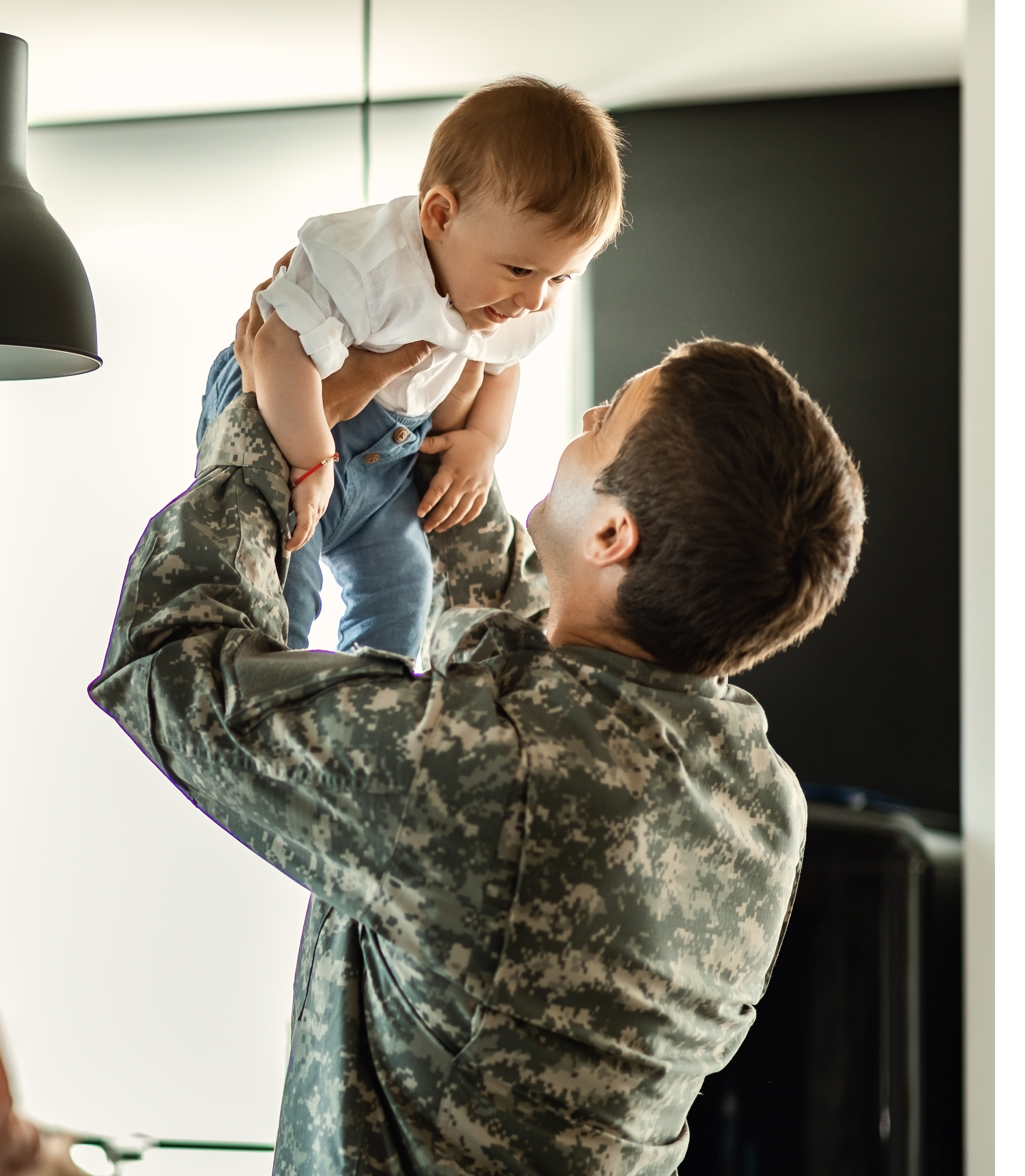 veteran parent lifting baby ready for VA loan