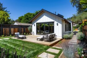 Professional photo of a single-level ADU with modern farmhouse style, frontal elevation view, showcasing the backyard in Marin County, California.